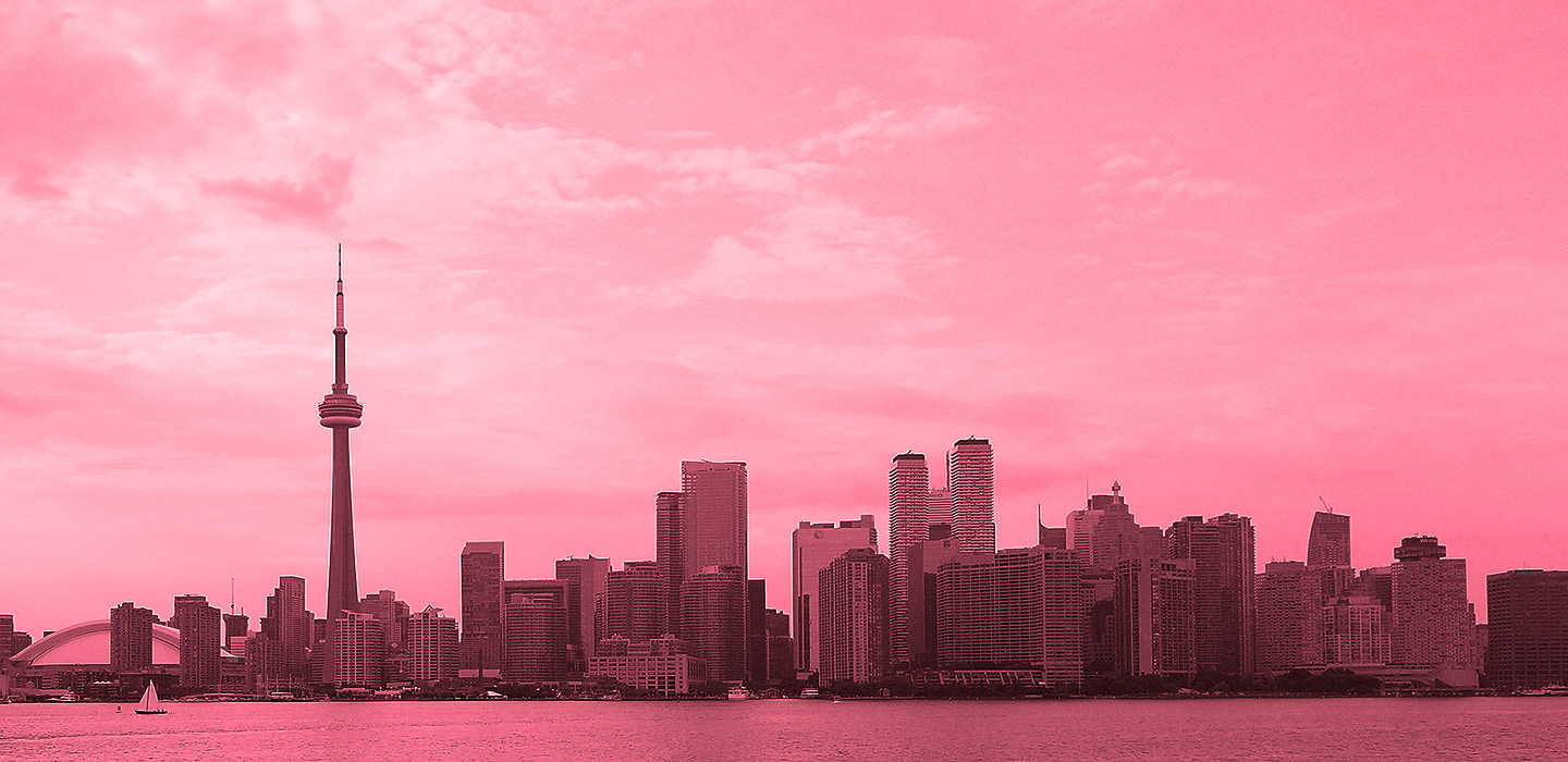 Pink-tinted city skyline with tall tower.