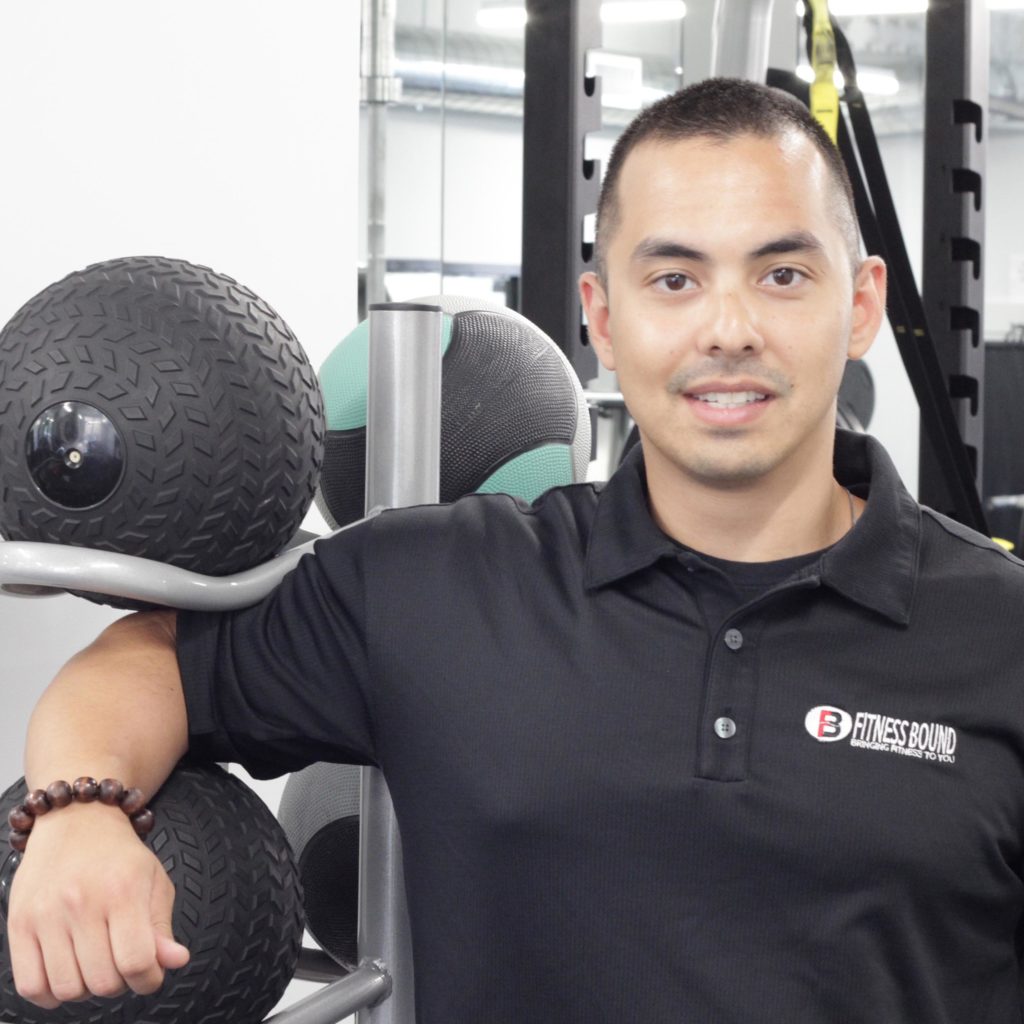 Man standing in gym with equipment.