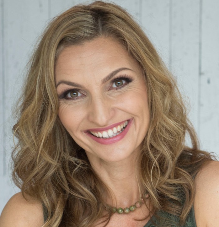 Smiling woman with wavy blonde hair.