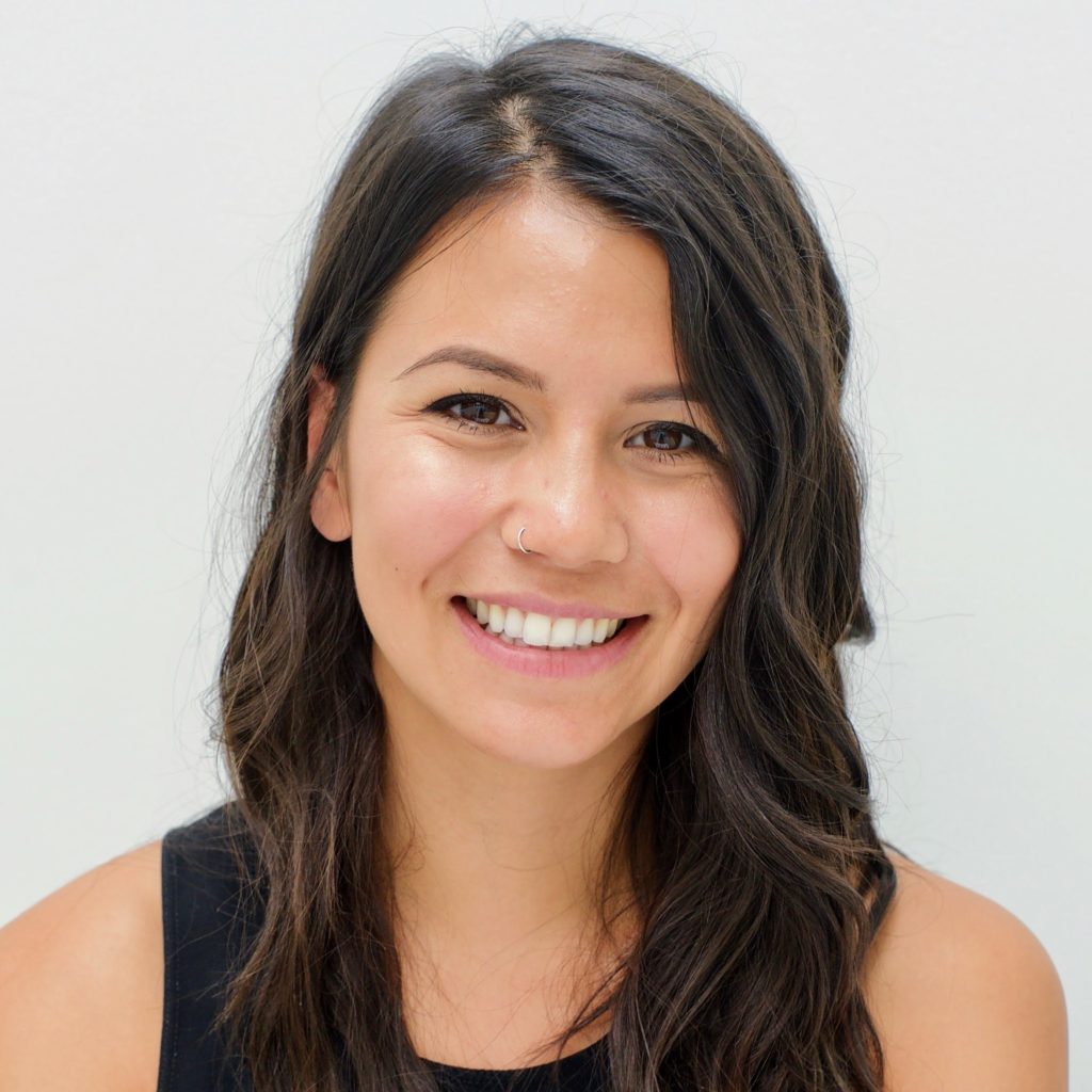 Smiling woman with long dark hair.