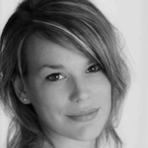 Woman smiling in black and white portrait.
