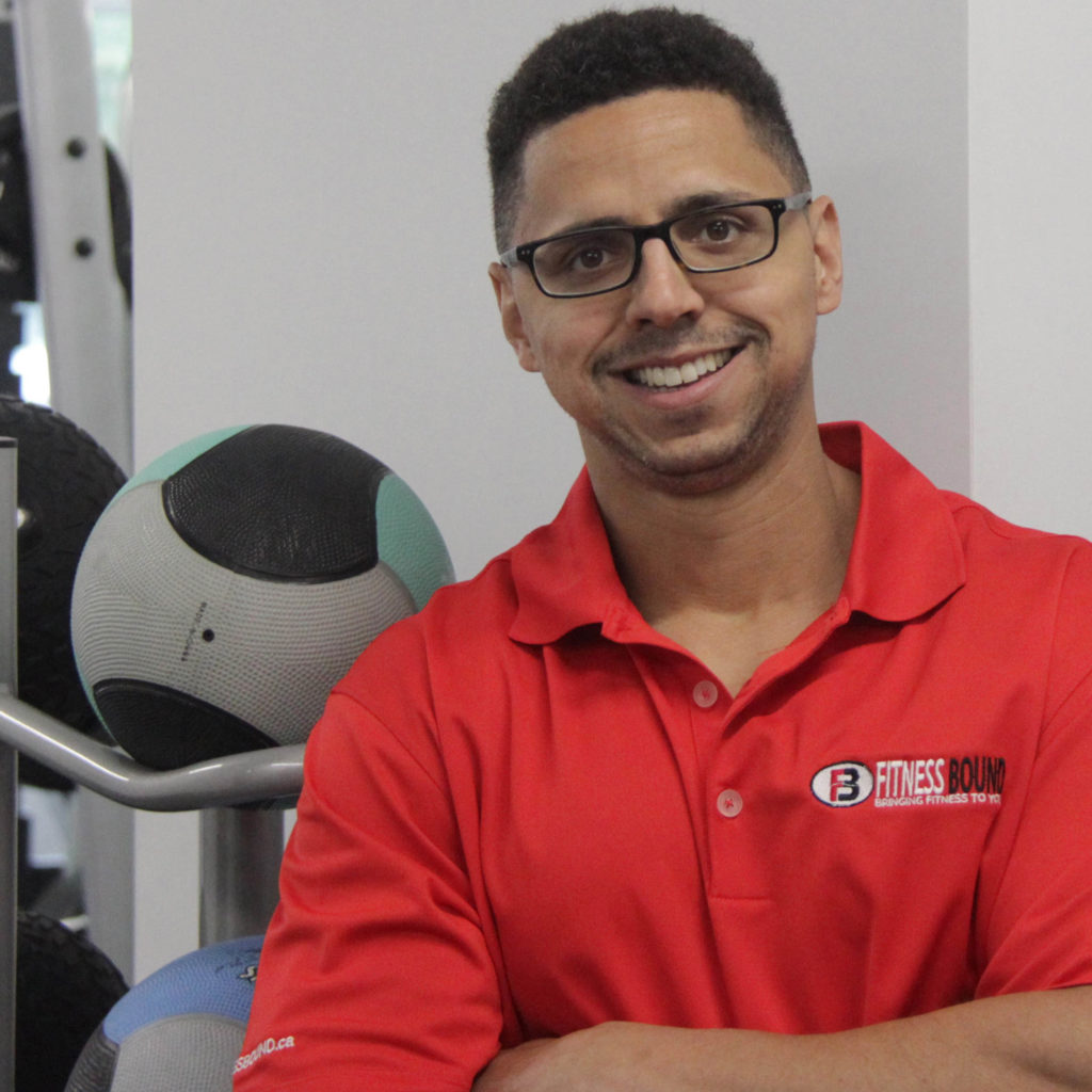 Man in red shirt near exercise equipment.