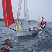 Two people sailing on a small boat.